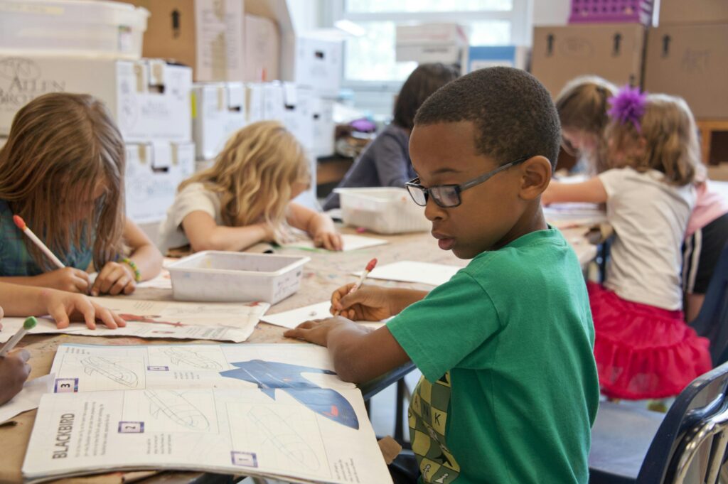 Group of children sitting at a table coloring