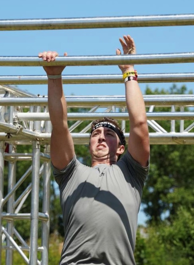 Spartan Race Warrior on monkey bar obstacle
