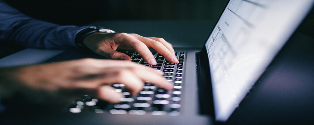person typing on laptop