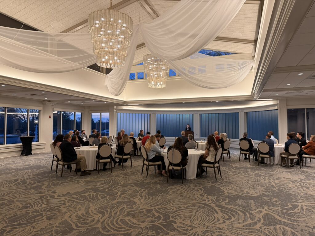 photo of an event space with chandeliers and tables with people sitting