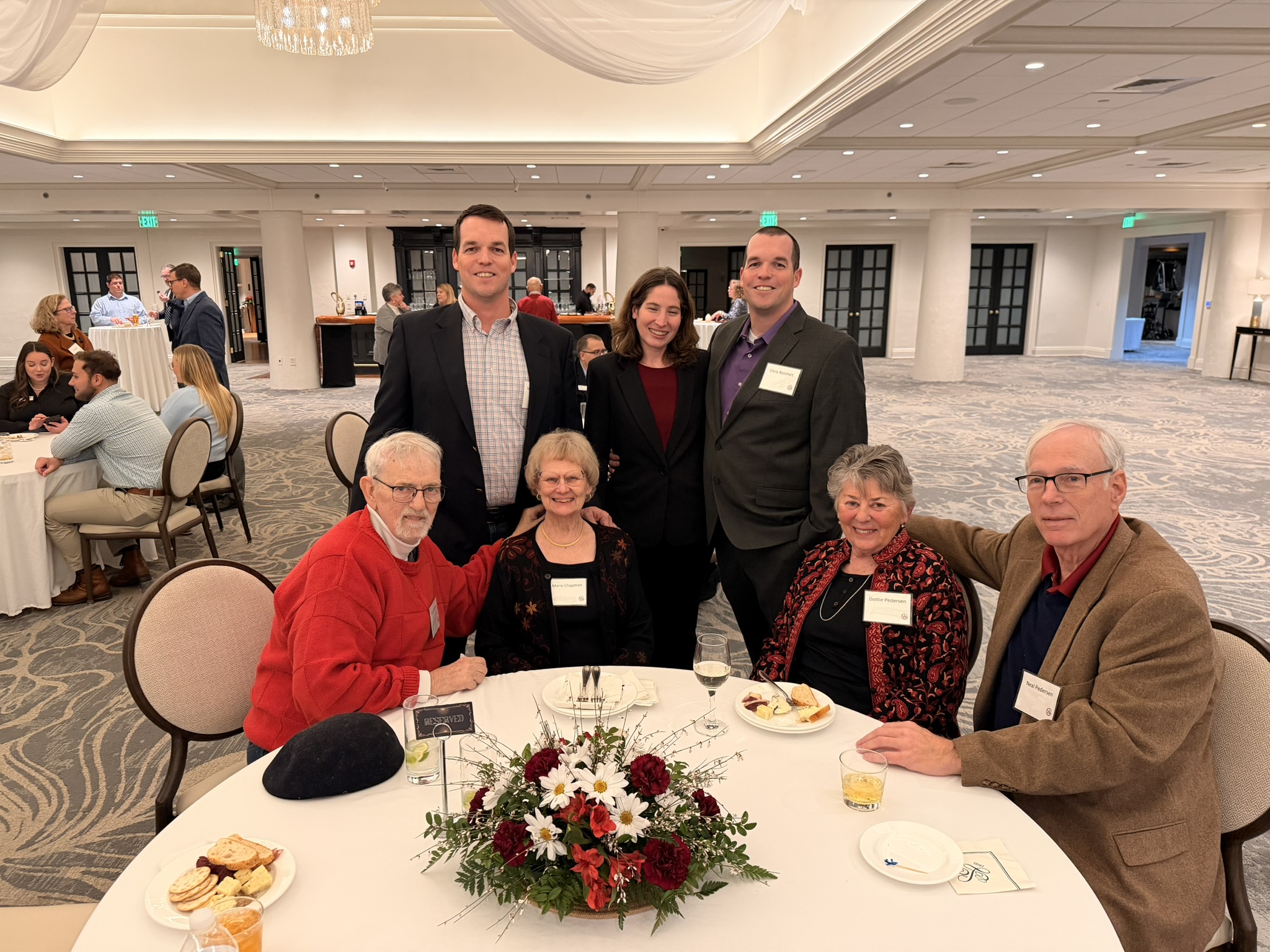 photo of a group of people sitting around a round table