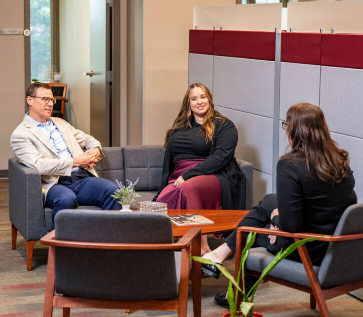 staff sit around in the lounge area connecting